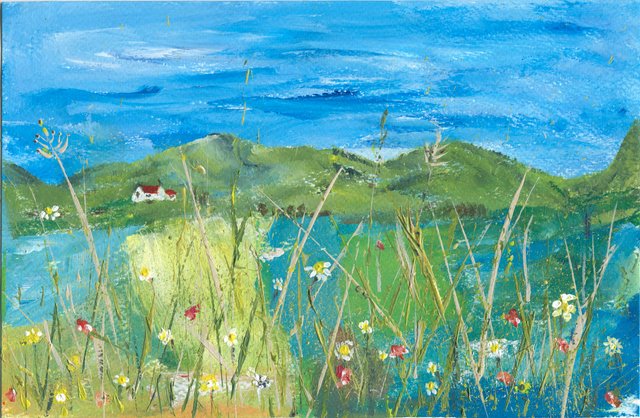 A meadow of daisies and poppies with tall grass stems lies before green hills, a white cottage and a bright blue sky.