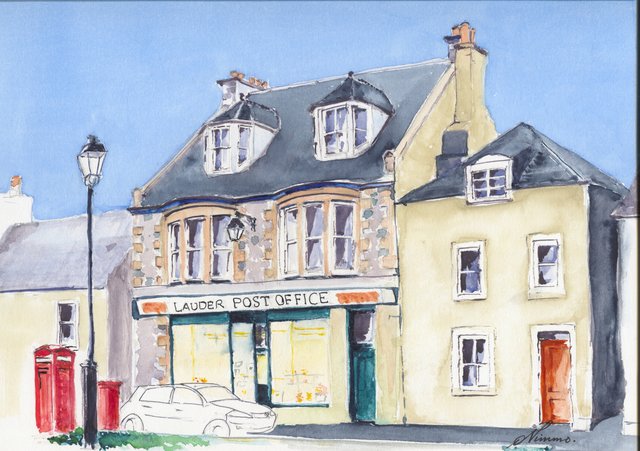 Lauder Post Office, a cream shop front with bay windows and dormers, beside a red telephone box and post box, a street lamp and a parked car.