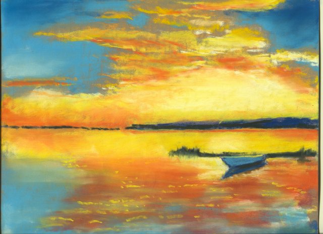 A blue rowing boat rests on calm water that reflects an orange and yellow sunset under a cloud-streaked blue sky, with a dark shoreline beyond.