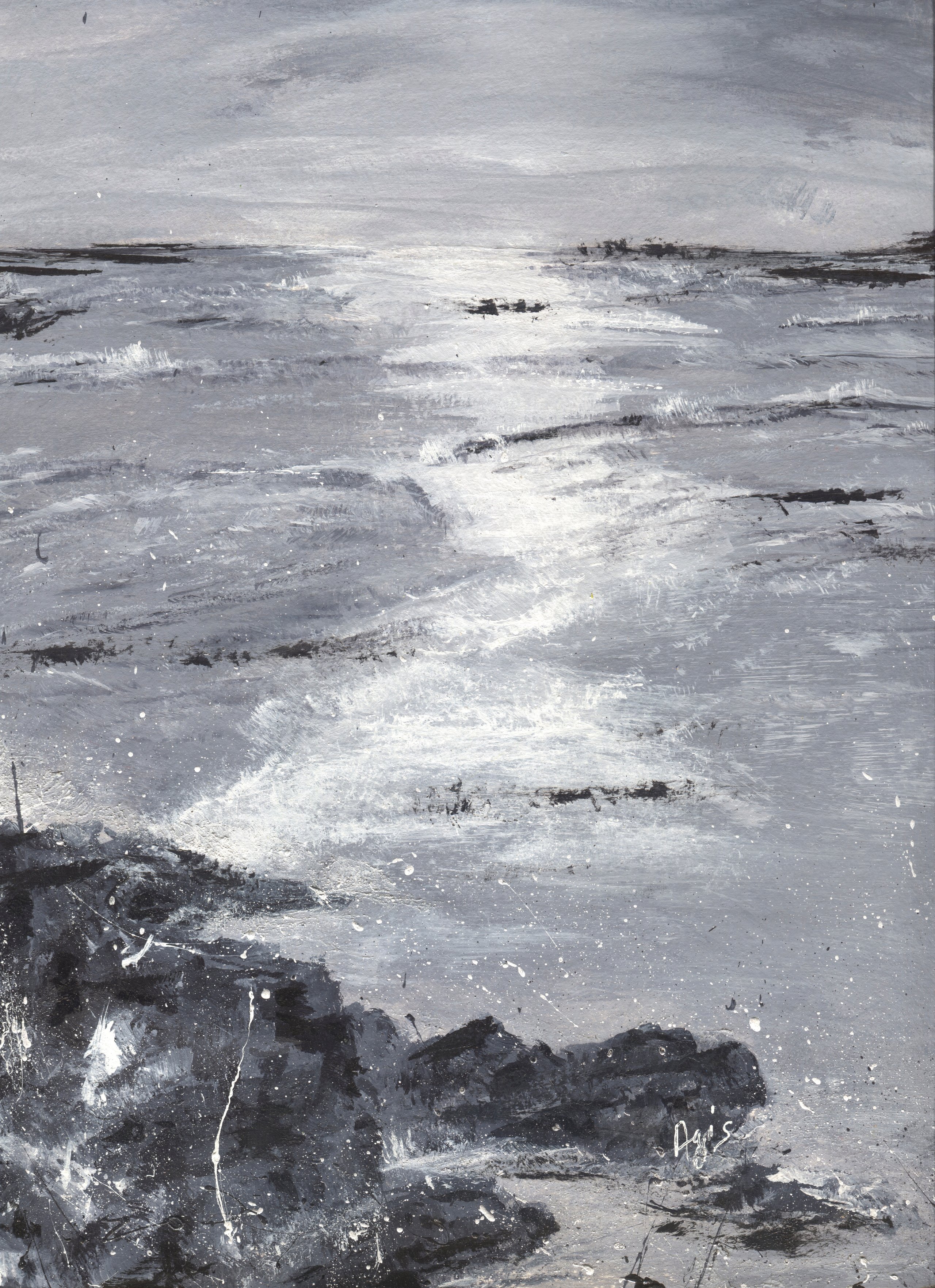A grey sea under a grey sky, with white light breaking on the water and dark rocks spattered with white in the foreground.